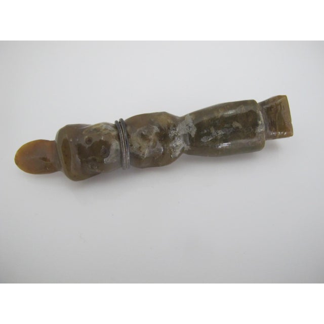 Chinese carved jade green colored mottled stone figure. Possibly a Chinese attendant. Has metal wire wrap with loop so can...