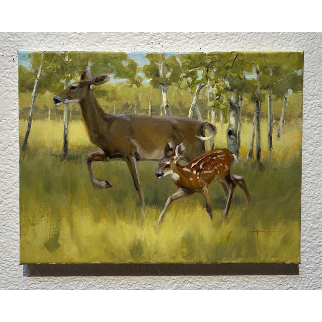 This oil painting captures a serene moment in an aspen meadow, featuring a graceful deer and its fawn in mid-stride among...