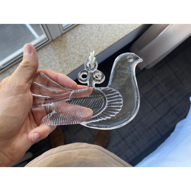 Here is a vintage Kosta Boda glass dove suncatcher, a notable piece of Scandinavian art glass designed by Bertil Vallien...