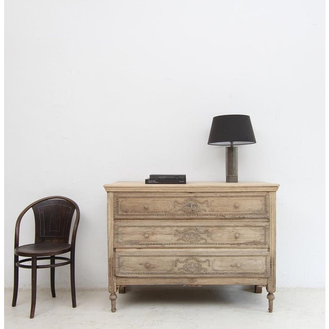 A provincial Neoclassical chest of drawers from the early 19th century. Louis XVI style. Crafted from solid oak with a...