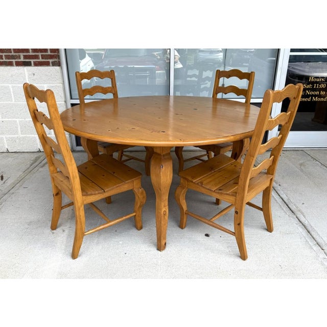 This seven-piece solid pine dining set, made in Mexico, features a generous round tabletop, warm natural finish, and six...