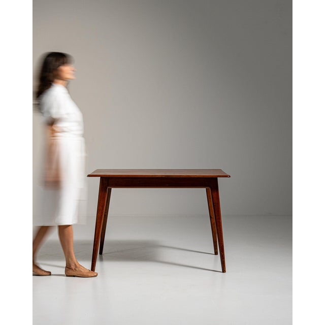 Tapered-leg walnut console in Rich Walnut Brown. The rich walnut brown surface highlights simple tapered legs, single...