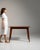 Tapered-leg walnut console in Rich Walnut Brown. The rich walnut brown surface highlights simple tapered legs, single...