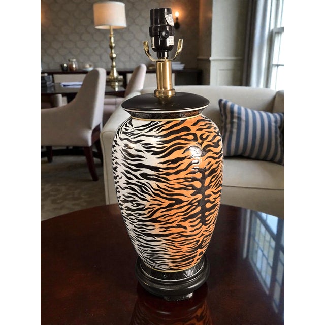 The Hollywood Regency Decorative Animal Print Tiger Ceramic Table Lamp is a stylish and unique lighting piece perfect for...