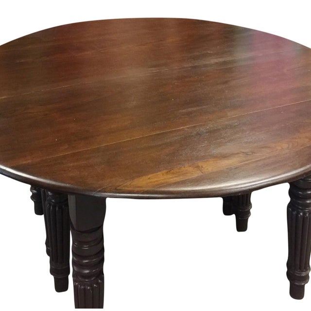 Bring timeless character to your dining space with this antique round dining table handcrafted from solid teak wood....