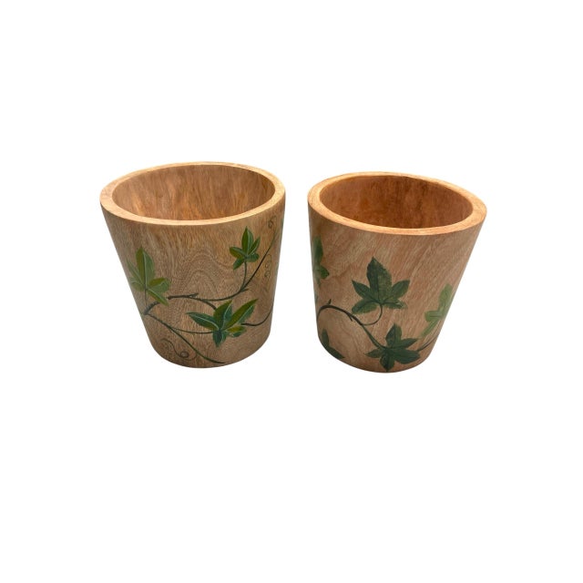 Enhance your indoor greenery, loggia, or foyer with this charming pair of vintage teak wood cache pots. Masterfully turned...