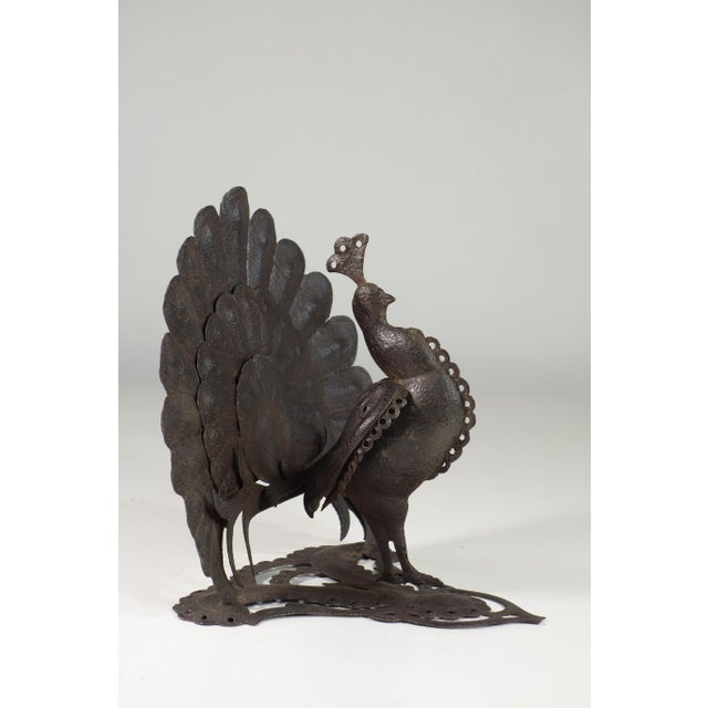 This is a wrought iron sculpture of a peacock, crafted in the Art Nouveau (Liberty) style. The peacock is depicted in a...