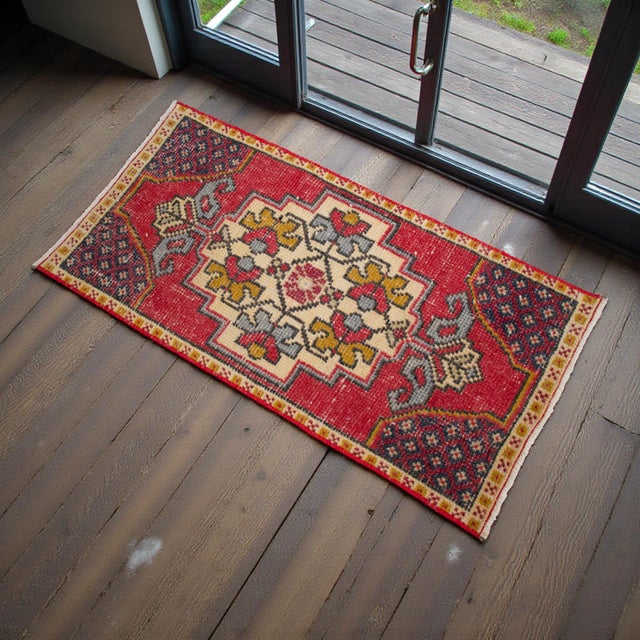 This charming hand-knotted small rug showcases a vibrant yet softly aged aesthetic, perfect for adding a touch of soulful...