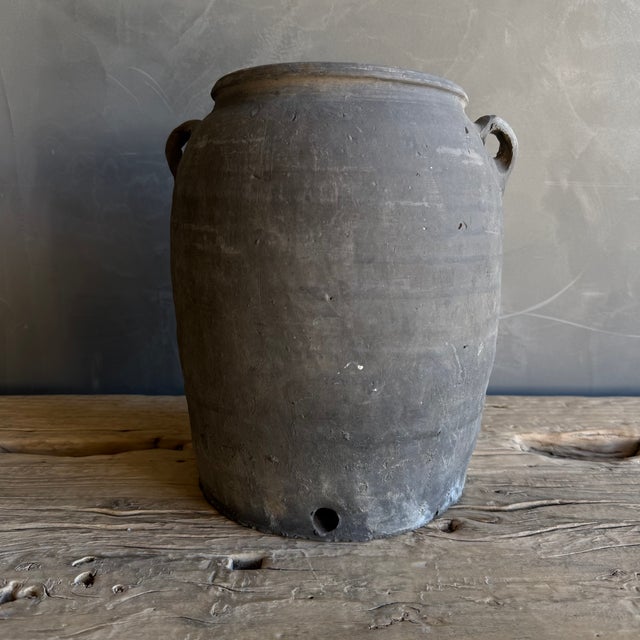 This exquisite vintage clay pottery piece showcases a stunning matte gray finish that beautifully accentuates its unique...