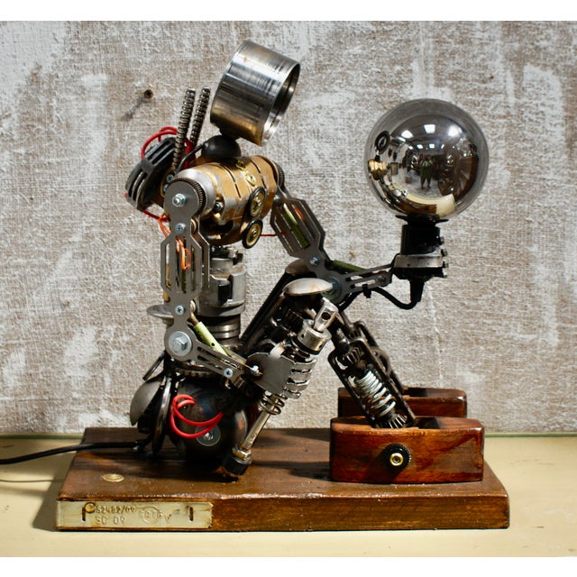A fantastic custom steampunk sculpture. Completely made from industrial components, including car parts, carpenters plane...
