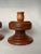 A pair of Mid Century Modern solid wood turned candle holders are in a warm light chestnut stain, carved throughout with a...