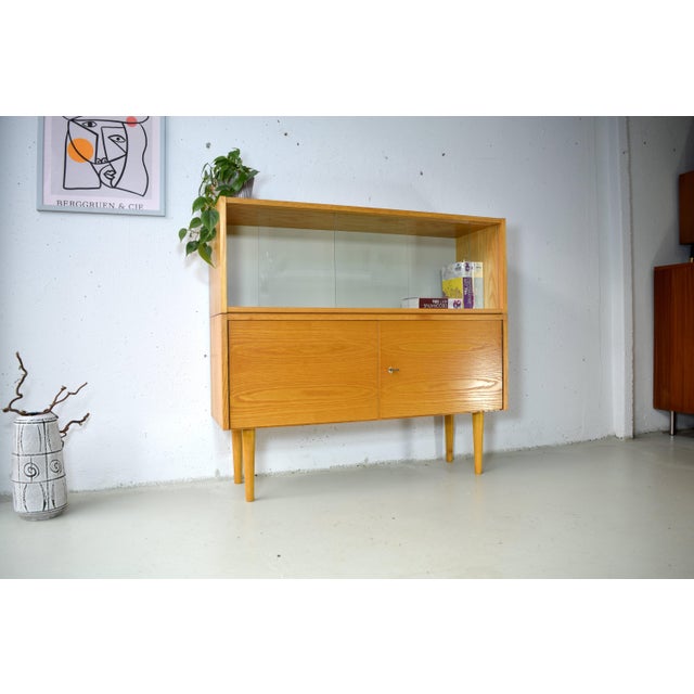 This beautifully designed cabinet is a genuine German Hellerau original from the 1960s. The piece features a minimalist,...