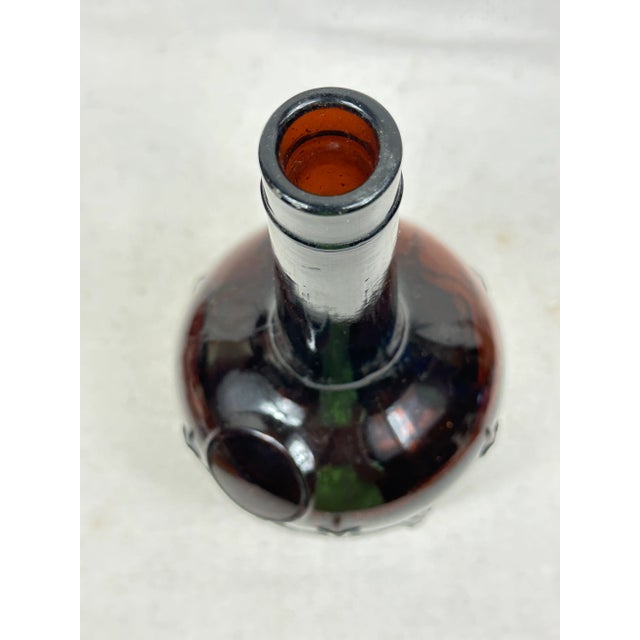 Antique amber liquor figural bottle depicting six monks under arches. This is a pre-owned item so please see all pictures...