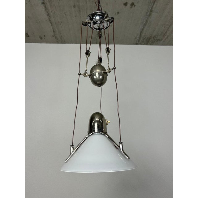 Art deco adjustable hanging lamp in very nice original condition. Up to 250V (Europe/UK Standard).The wiring of this item...