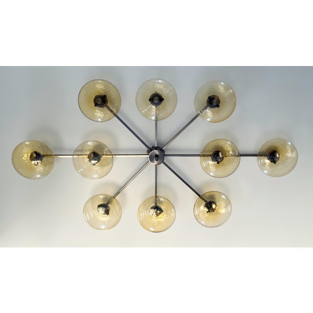 Italian midcentury flush mount with ten amber Murano glass shades carefully hand blown with bubbles inside the glass using...