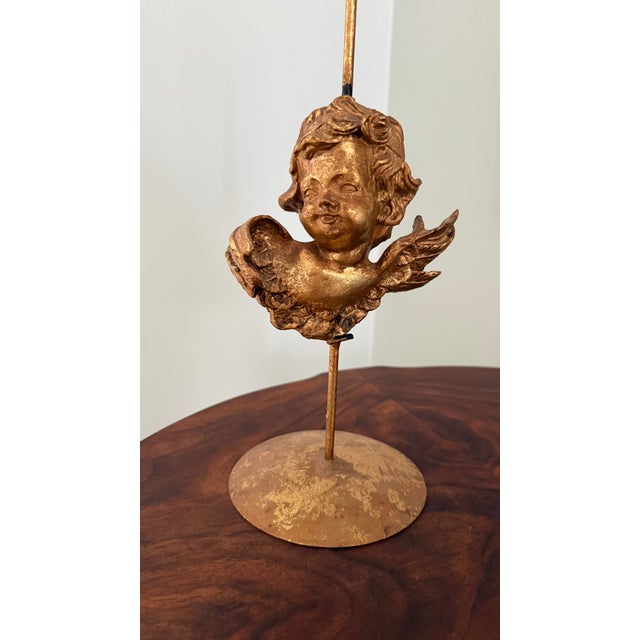 Vintage gilt cherub taper candle holder in the Hollywood Regency style, sourced from an artist's estate sale from the...