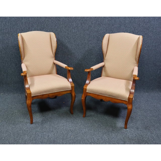 Pair Hickory Chair Co French Style Wing Host Armchairs, cream upholstered seat and back, back of chair with striped floral...