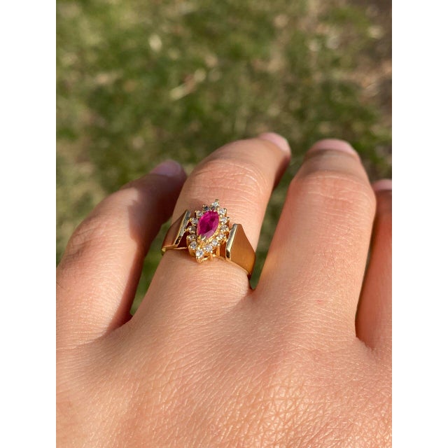 The Stockport: Vintage 1980's Ruby Navette Ring with Natural Diamonds. This captivating ring features a stunning 0.31...