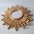 This striking mirror is designed in the shape of a stylized sun. The round mirror surface is located in the center and is...