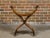 An Italian Renaissance style walnut Savonarola folding chair from circa 1900 with lion paw feet. This Italian Renaissance...