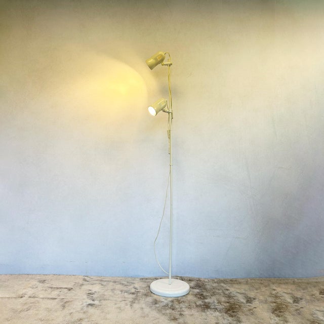 Twin spotlight floor lamp by ring lighting, 1960s-70s. Features two independently adjustable conical shades in cream...