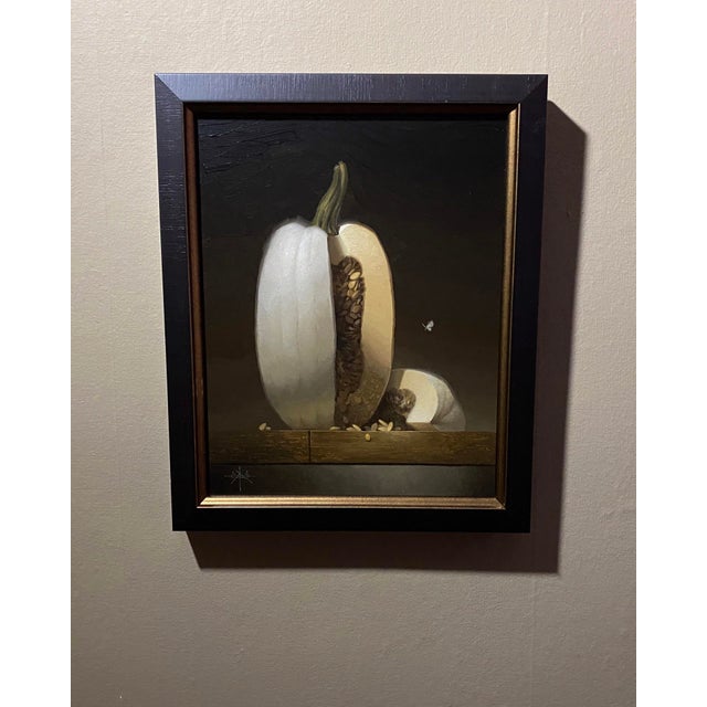 This artwork presents a beautifully rendered depiction of a halved white pumpkin, revealing its intricate interior filled...