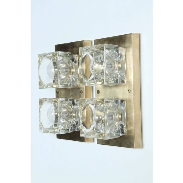 Pair of brass and glass sconces by Sciolari. The rectangle brass plates each support two glass cube blocks, and they have...