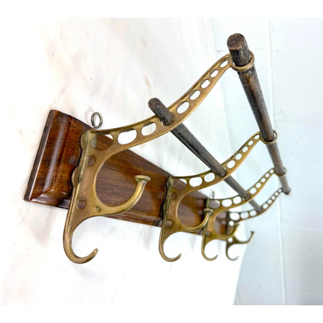 The antique wall mount brass and wood wall hook/rack is a stylish and functional addition to any home. Crafted from brass...