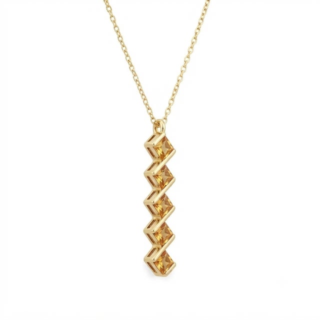 Sophisticated geometry meets sun-kissed elegance. Fall in love with this striking vertical bar pendant necklace. Featuring...