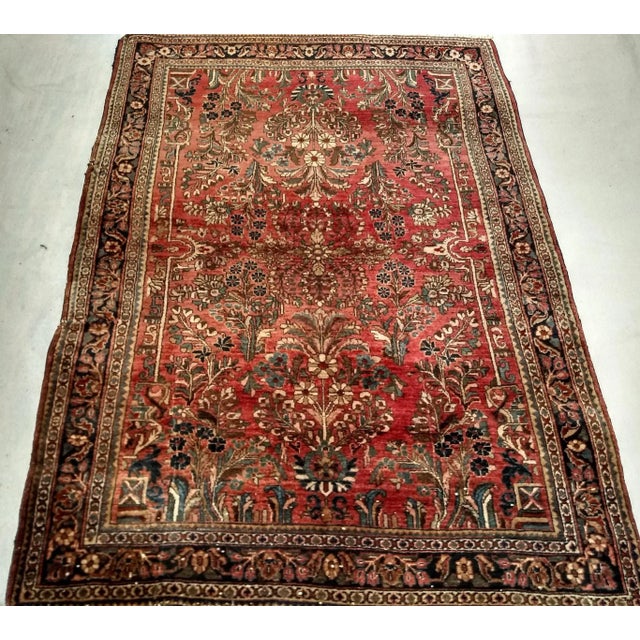 An exceptional antique Persian Sarouk rug from the first quarter of the 20th century, handwoven with remarkable...