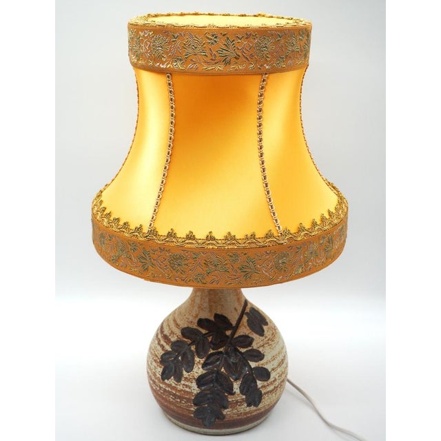A lovely rustic handcrafted vintage lamp with a beautiful big brown leaf on one side that brings nature into the home....