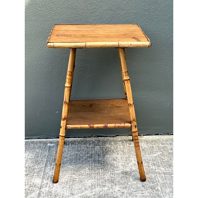 This charming vintage bamboo side table captures the effortless elegance of mid-century tropical design. Meticulously...