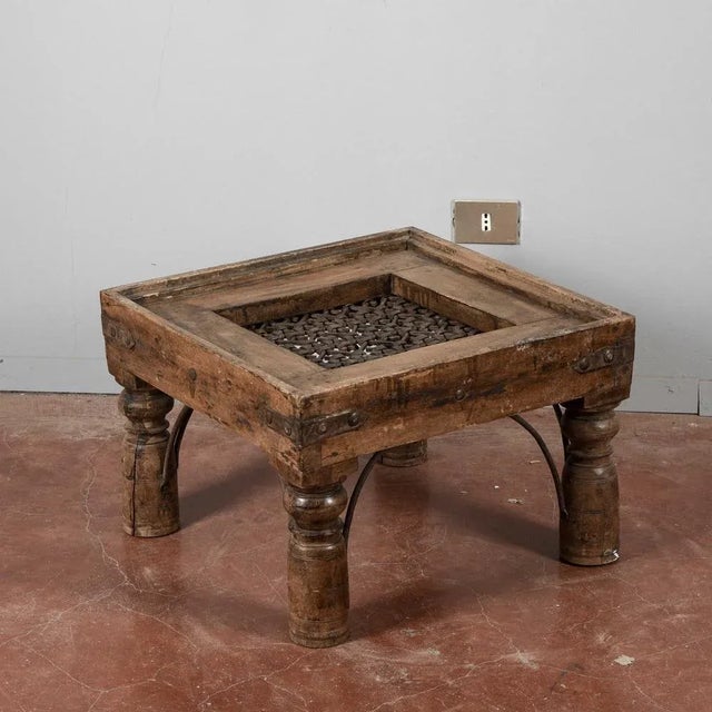 This striking coffee table was created from an old window grille, transformed into a unique and functional piece of...