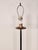 A pair of wrought iron torchères with gilt accents, circa 1970. Height measures 66.5" finial, 57.5" harp.