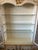 An exceptional and highly decorative bonnet-top display cabinet by John Widdicomb, showcasing the sophisticated...