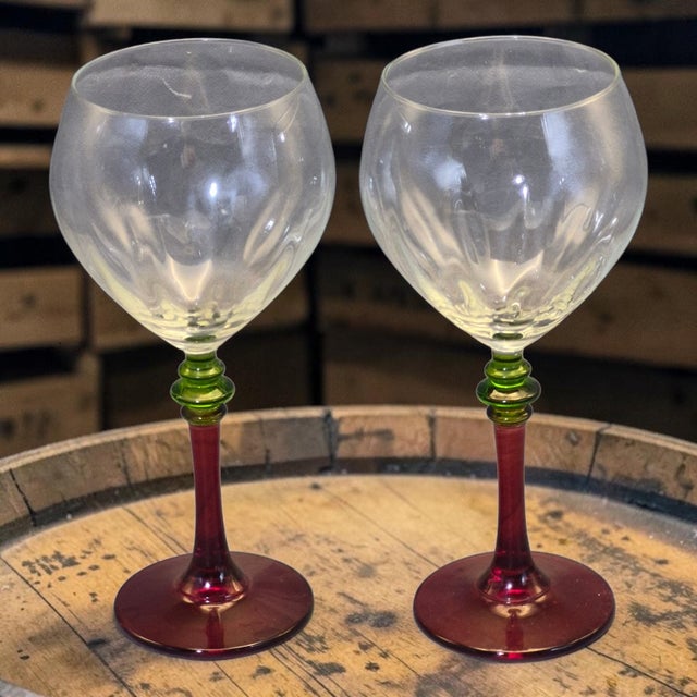 The Stunning Festivo Italian Pair of Wine Glasses feature a unique red and green stem design, adding a touch of elegance...
