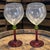 The Stunning Festivo Italian Pair of Wine Glasses feature a unique red and green stem design, adding a touch of elegance...
