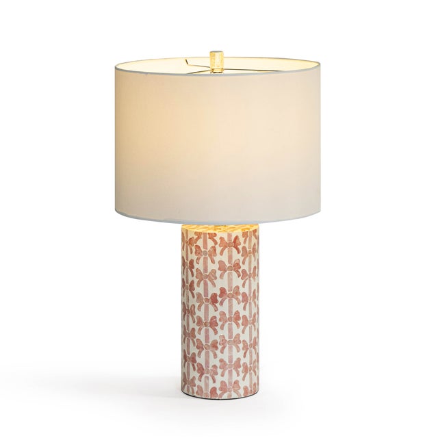 The Lassy Pink Ribbon Capiz Shell Table Lamp brings a cheerful glow and a touch of whimsy to any space. Natural Capiz...