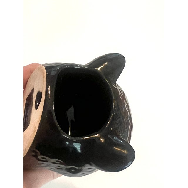 This vintage 80's Quail Ceramics panther wall vase features a striking black glossy glaze with textured indented spots....