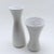 Two coordinating West German ceramic vases by Scheurich, with light texturing and white glaze over beige finish. Dated to...