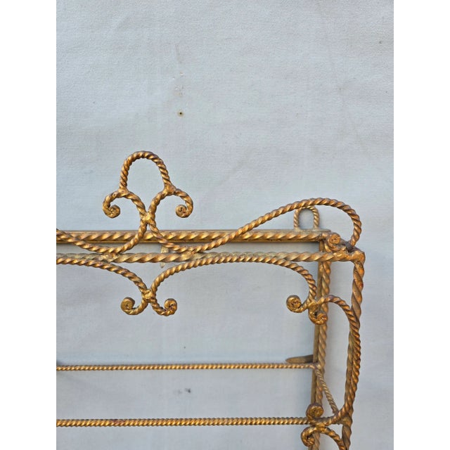 This is an exquisite hand forged gilt wall shelf from Italy. There are two small metal tags that are wrapped around the...