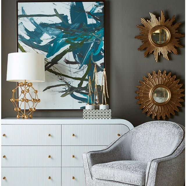 The delicate radial pluming of our hand-carved Santo mirror is inspired by an archer's arrow. Hand finished in exquisite...