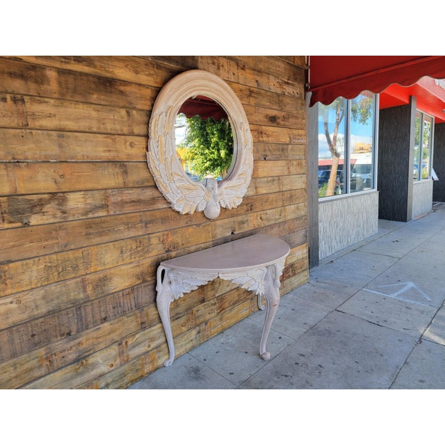 Vintage modern French style solid carved wood demi lune console table with a round hanging wall mirror. console table has...