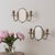 Beautiful pair of brass and mirror sconces from France, 1940s. Oval beveled mirror with two curved brass arms and ball...
