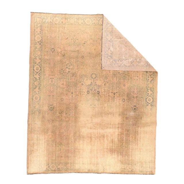 This vintage piece has been treated to subdue the colors and reduce the pattern, resulting in a partial light blue rosette...