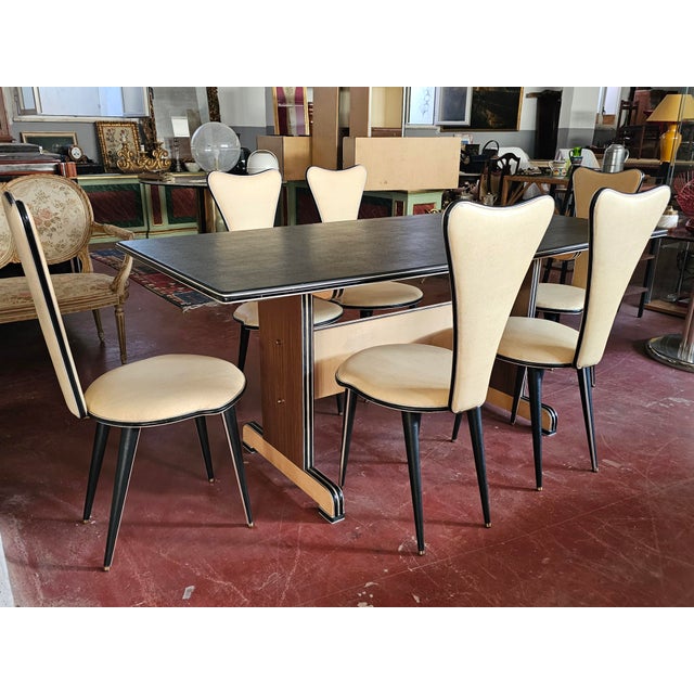 Elegant dining set made in the 1950s by Umberto Mascagni. The set consists of a table and six chairs, all completely...