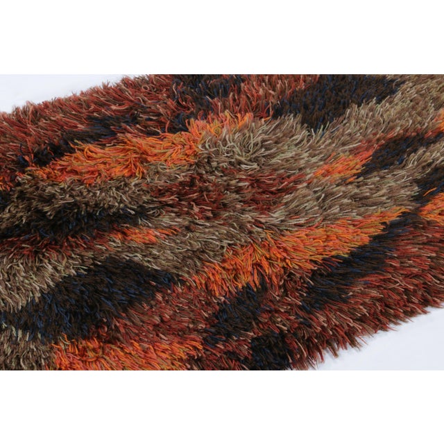 Hand-knotted in lush, high-pile wool in Sweden circa 1960-1970, this 2x4 vintage Swedish Rya runner rug is a bold new...