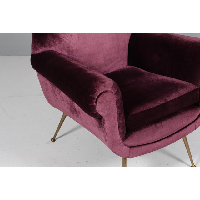 Armchair designed by Gigi Radice for Minotti. Made with solid wood structure and blue velvet covering and polished brass...