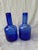 Heavy vintage handblown cobalt blue glass bottles. A pair that are very similar in shape to one another, but not exact....