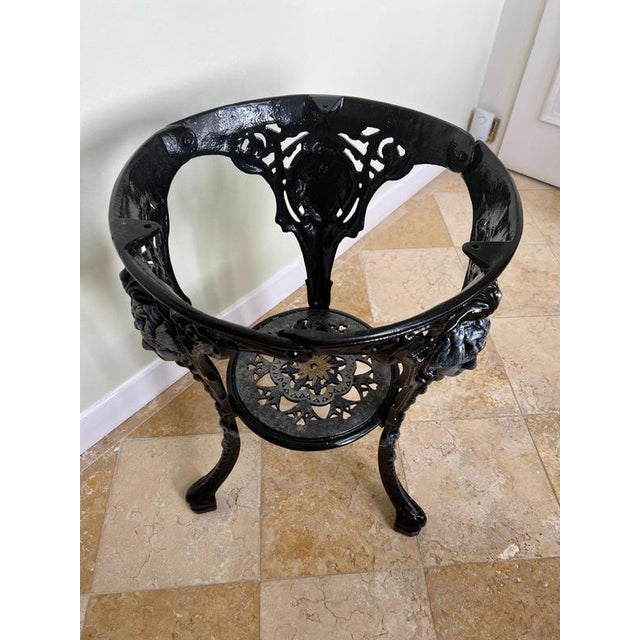 A hand painted, ‘Britannia’ cast iron occasional table. (Matching pair available).